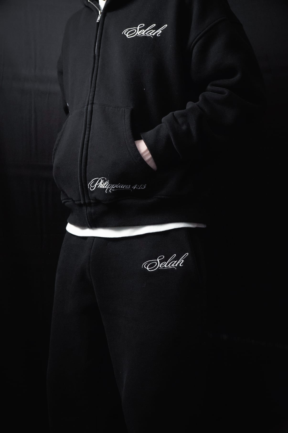 Front of the Rosary Zip Hoodie, half-zipped over a waffle tee